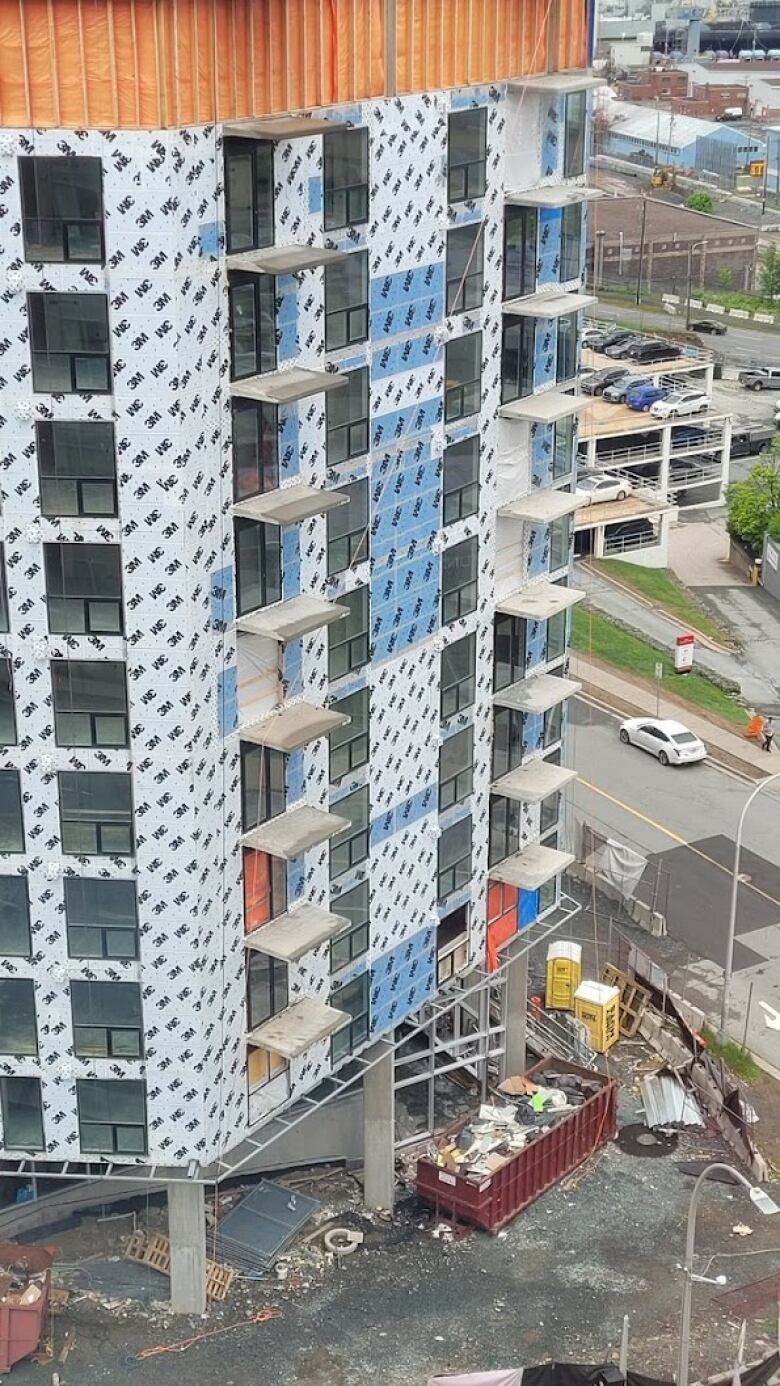 A photo of a construction site in Halifax. Several windows are now boarded up.