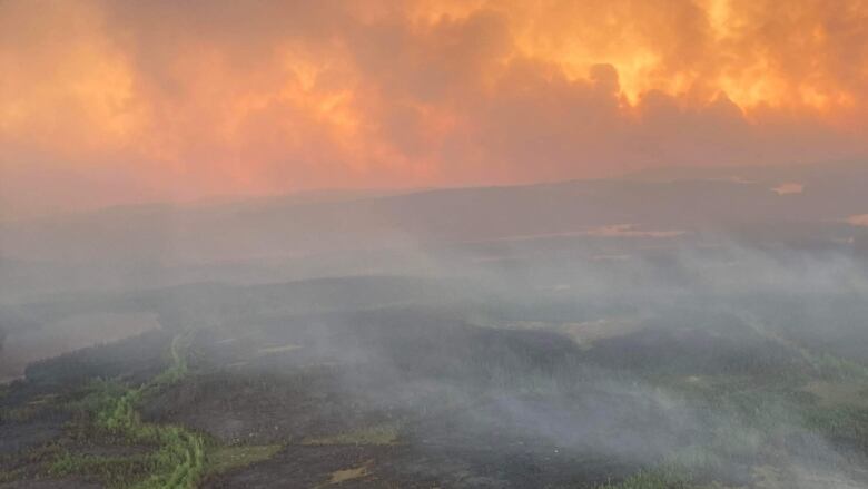 smoke and orange skies above Mistissini, Que.