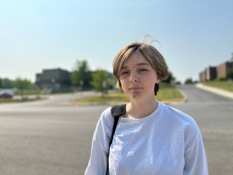 teen girl wears white sweater outside