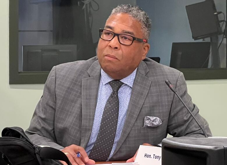 A man at a desk with a microphone.