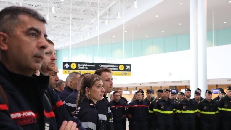 Firefighters lined up inside the airport