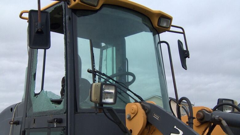 A construction vehicle with a broken window. 