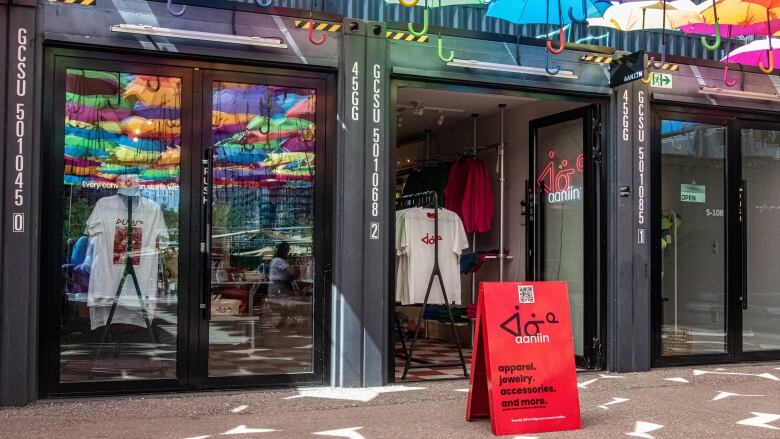 Storefront with a canopy of coloured umbrellas.