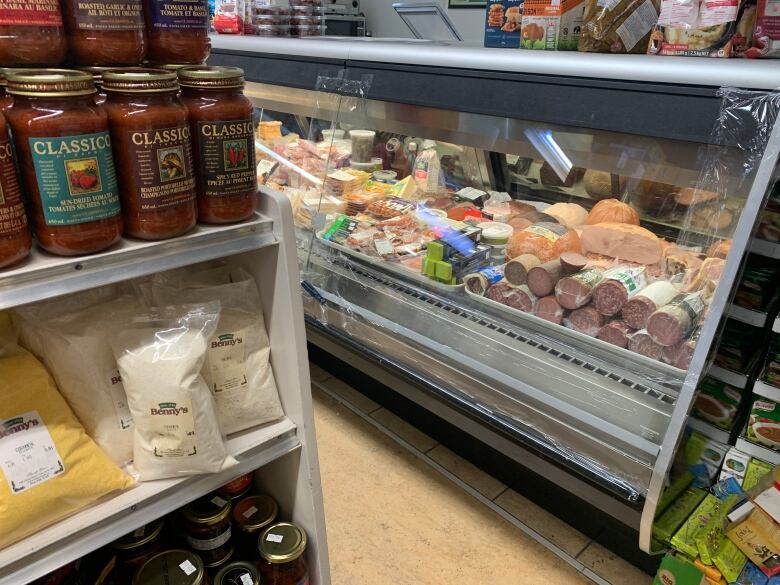 Sausages, spaghetti sauces and other Italian foods are for sale at a deli counter