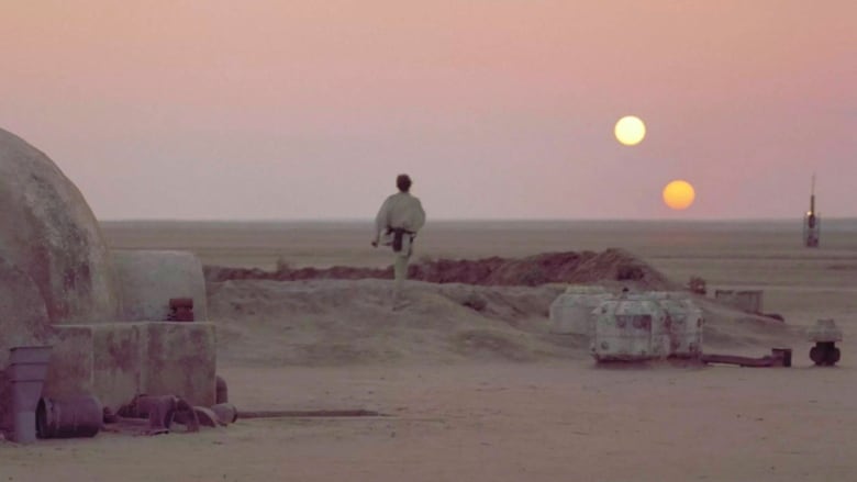 From Star Wars: Episode IV - A New Hope, Luke Skywalker stares out at a sunset of two stars from his home planet of Tatooine.