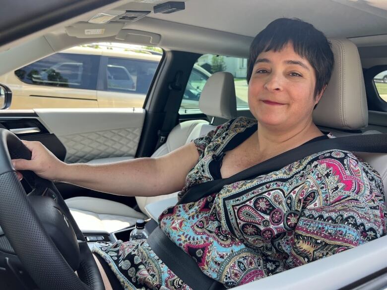 Jennifer Nemet is shown sitting in her new car.