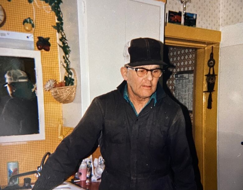 Joe Adams stands in a home.