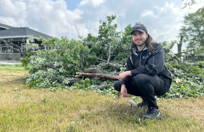 man stands by fallen tree