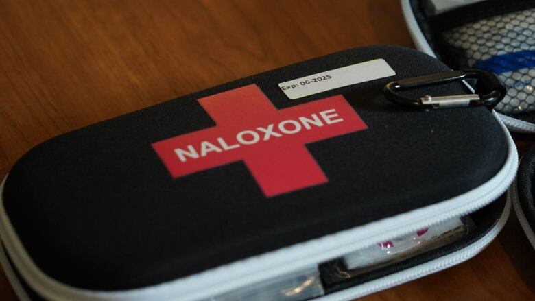 A Naloxone kit sits on a table. 