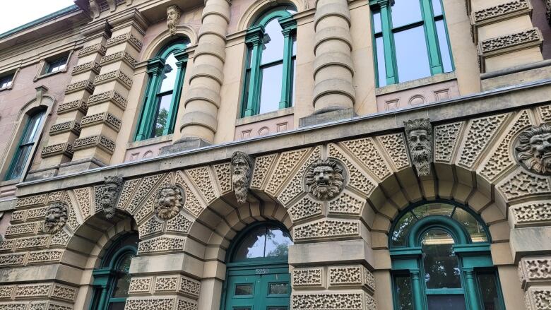 A sandstone building with green windows is shown. Halifax Court hearings are held inside.