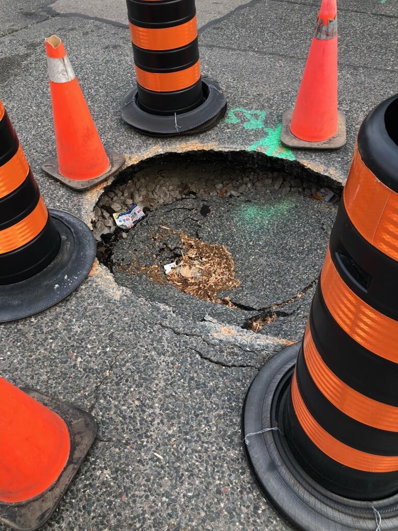 Neighbours say the section of roadway caved in on APril 13. Despite calls to the city, they say, it still has not been fixed. The city said in a statement to CBC Toronto a crew will be dispatched on Friday, June 16.