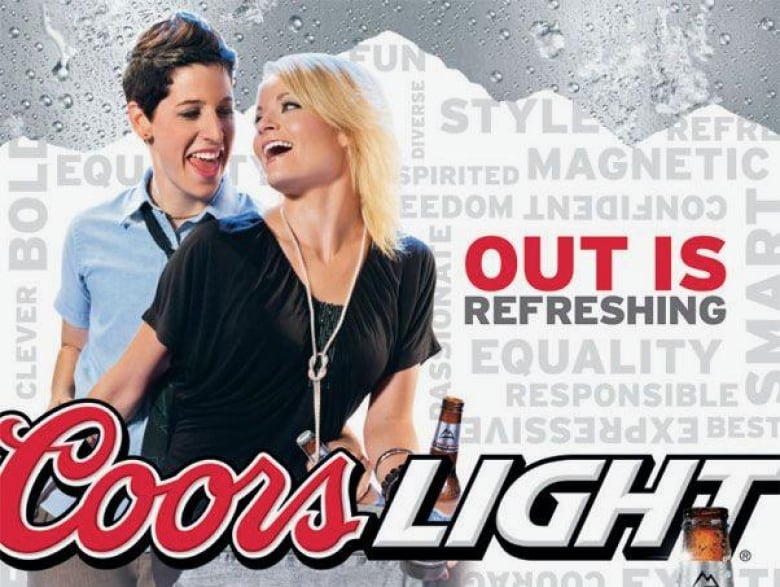 A brunette woman with short hair holds hands with a blonde woman with long hair. A Coors Light logo and the slogan Out is Refreshing are also there.