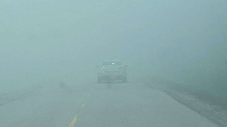 A police car in a smokey area.