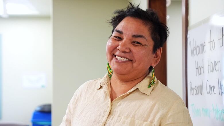 A woman smiles at the camera. 