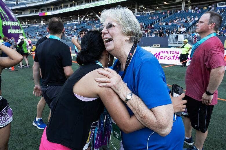 Two women share a hug.