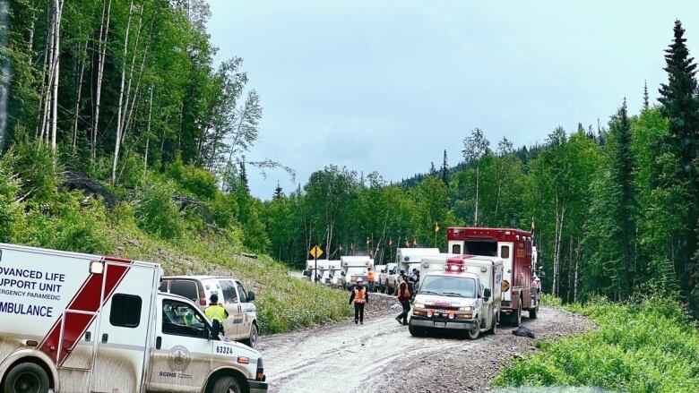 Ambulances on a dirt road.