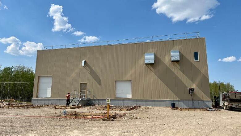 A large brown warehouse-like building, seen from the outside.