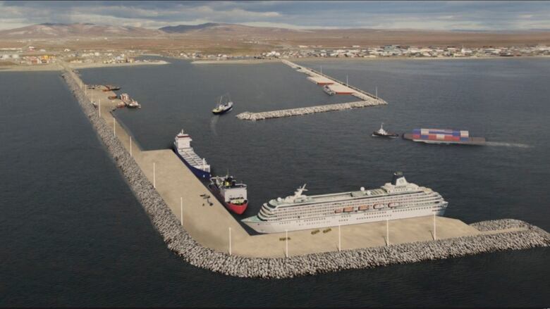 Gravel wharf with cruise ship parked alongside and some smaller boats.