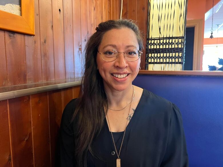 Gloria Ranger wearing a black dress and glasses