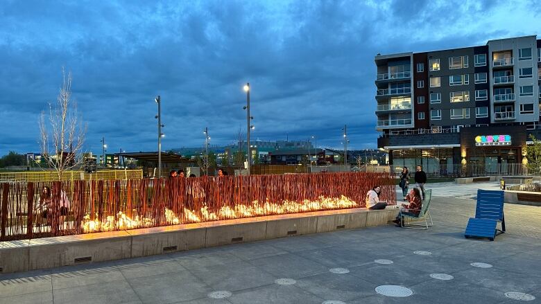 A large outdoor fire feature in the public plaza at University District.