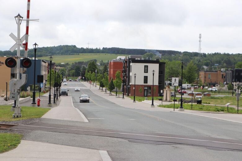 Cars drive along a main street.