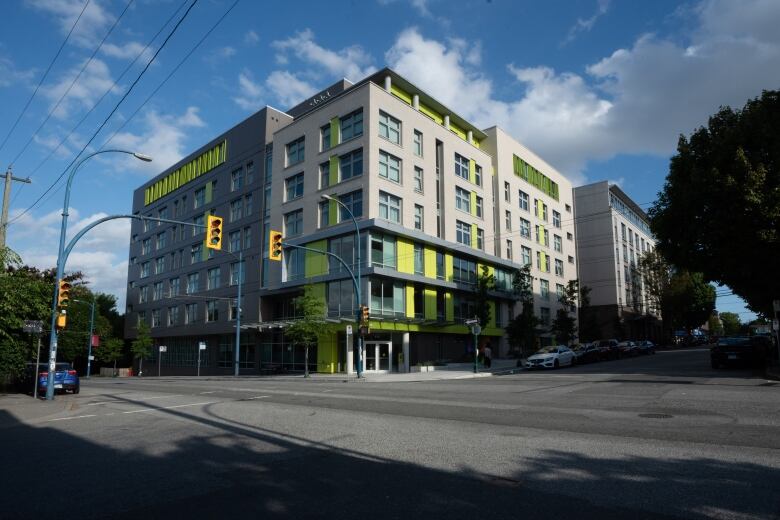 A grey building on a Vancouver street on a sunny day.