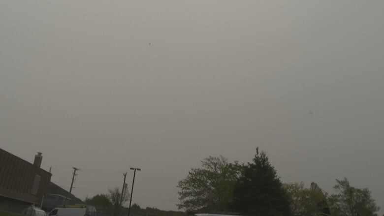 A photo of a dark grey, hazy sky.