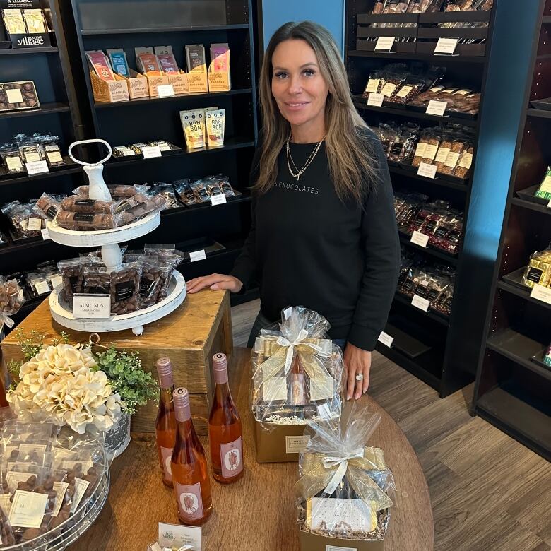 A woman standing with a bunch of chocolates