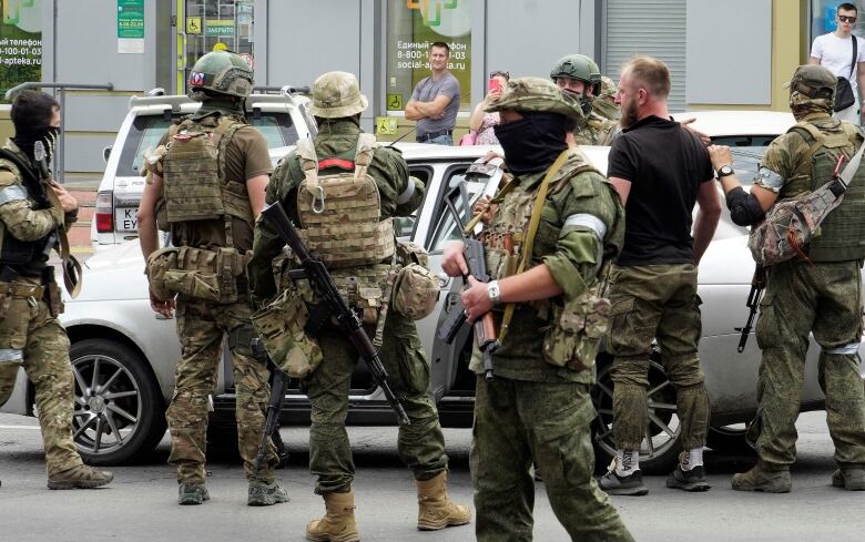 Members of Wagner group inspect a car in a street of Rostov-on-Don, Russia, on Saturday.