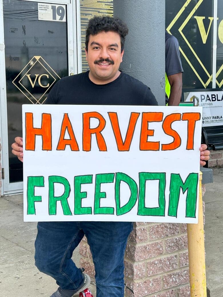 A man holding a sign that reads 