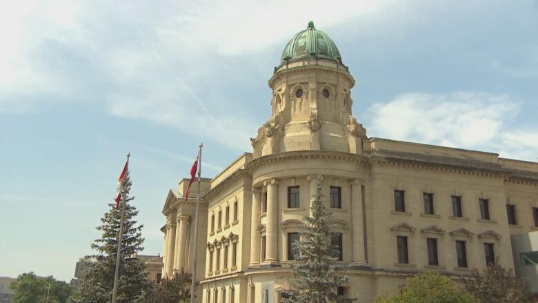 A law court building with a green-ish dome structure is seen.