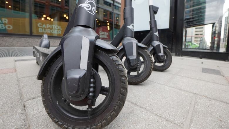 E-scooters on a sidewalk. 