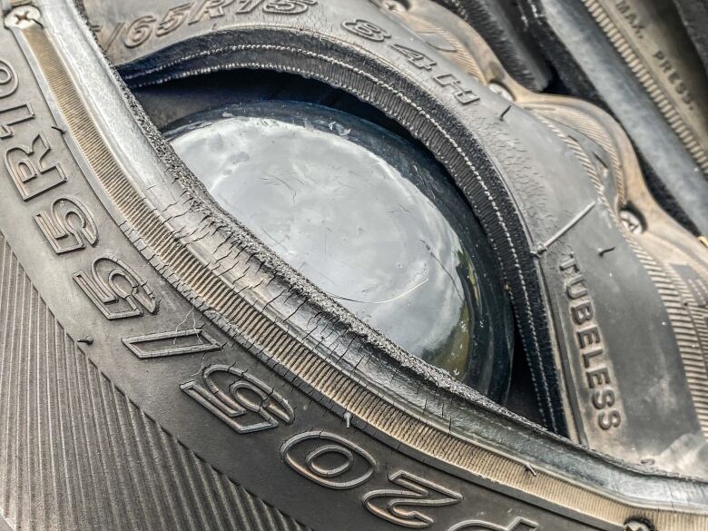 The glassy eye of the dead crow is framed by the sidewall of 16