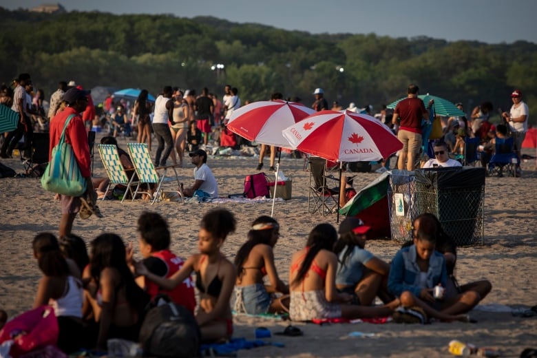 Crowds of people are seen on a beach.