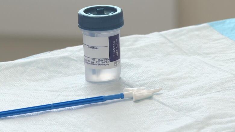 HPV Test sits on the counter with a small container and a swab