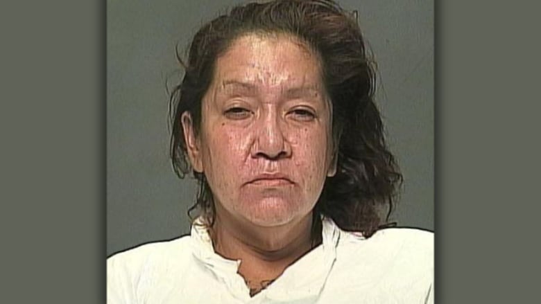 A mugshot of a woman with long brown hair. 