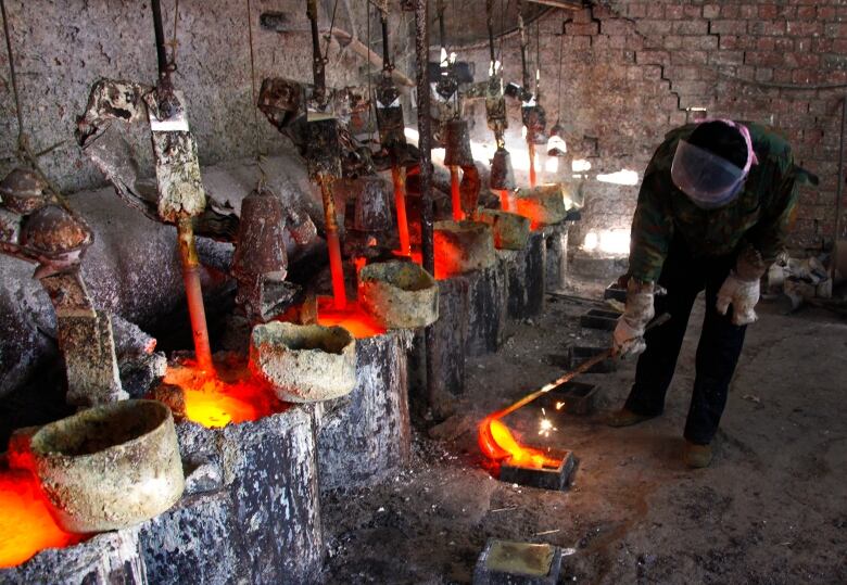 Worker near glowing-hot rocks