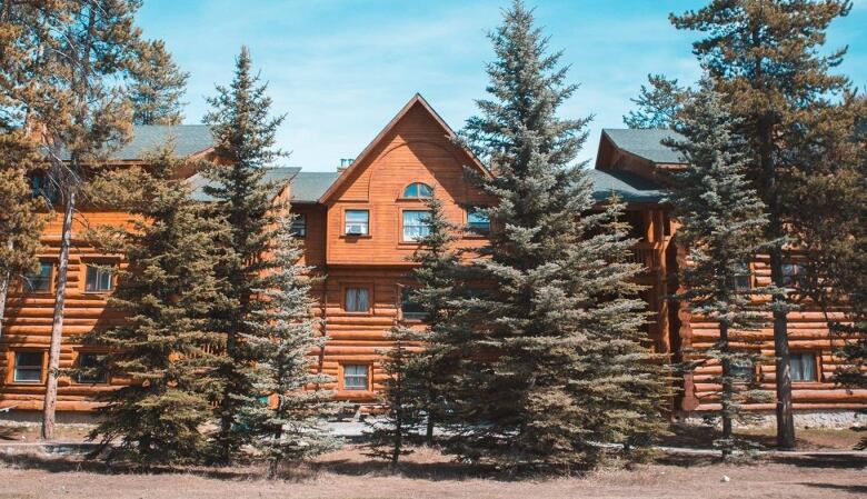 A log building is pictured.