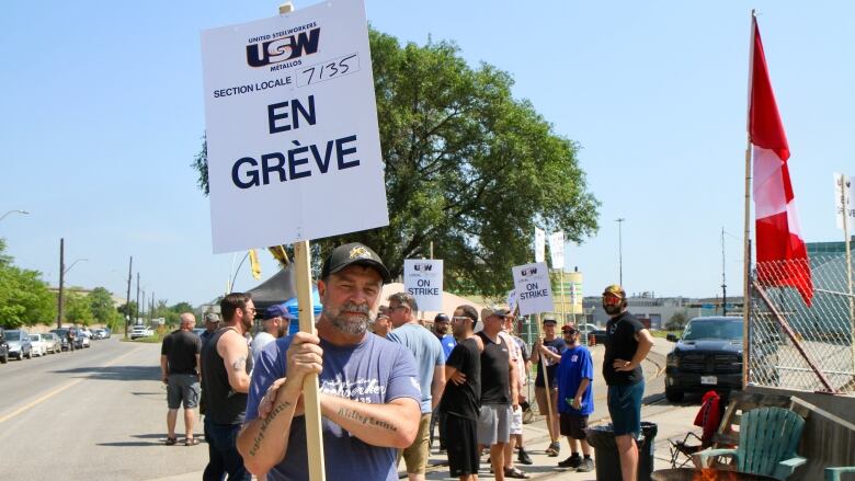 man holds sign