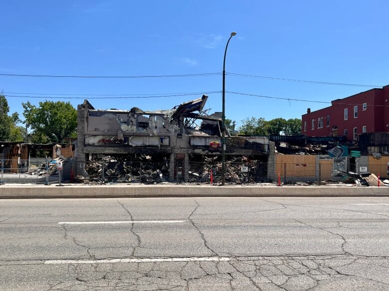 A wide shot of three extensively damaged buildings in Winnipeg. 