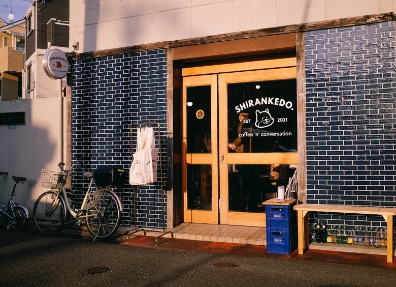 A brick storefront with a sign that says Shirankedo, featuring a squirrel mascot.