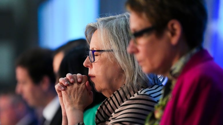 Green Party co-Leader Elizabeth May is seen praying.