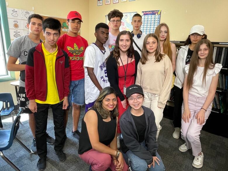 A group of youth standing together to pose for a picture.