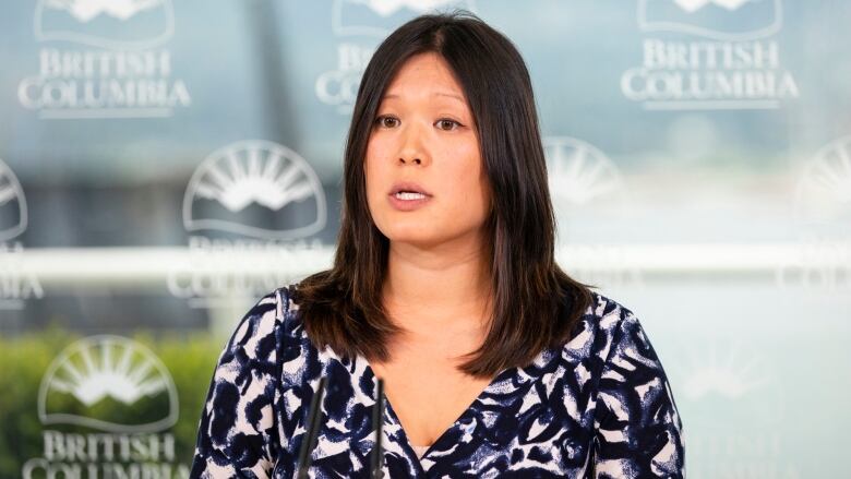 An East Asian woman speaks at a news conference.