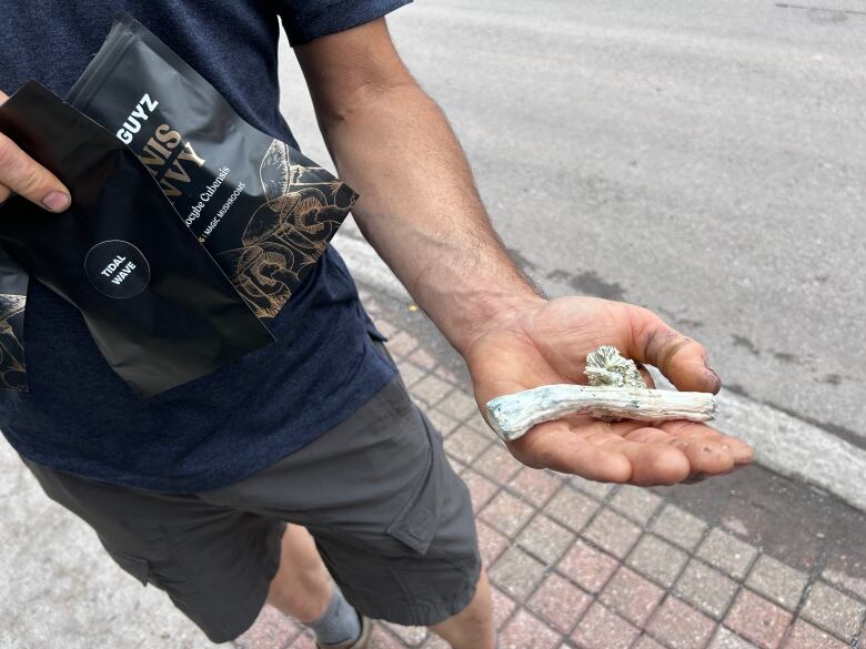 Man holding mushrooms.