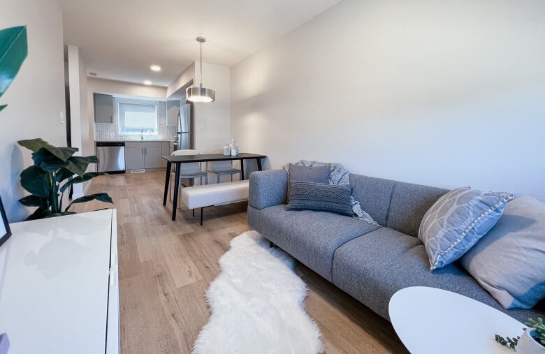 A open concept living and dining room with a window bringing in natural light.