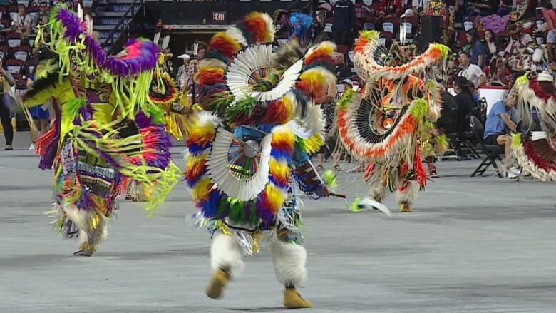 Dancers dressed in colorful costumes perform at the Stampede in Calgary.