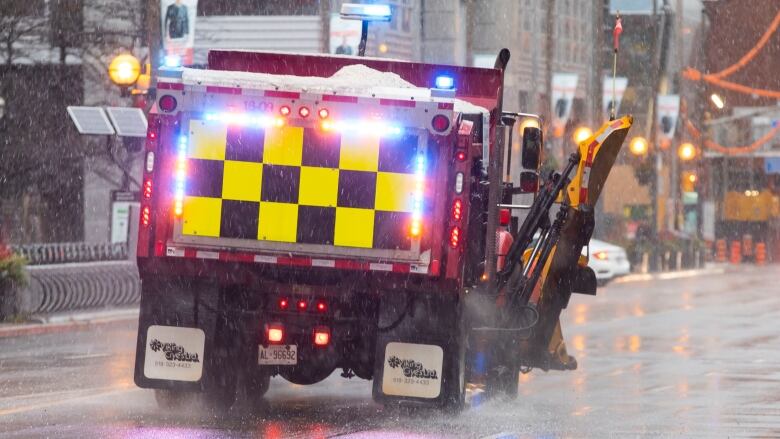 A snow vehicle going along Front Street during the wet snowfall on December 15, 2022.