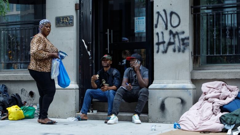 Asylum seekers from Africa and other locales are photographed outside of a shelter intake office at Peter St. and Richmond St. in Toronto, on July 14, 2023. A lack of Toronto shelter space has forced asylum seekers to sleep outside.