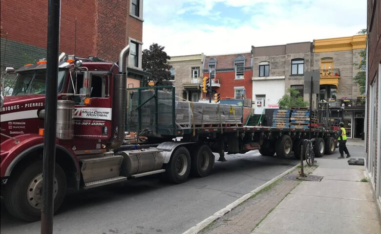 A truck takes a turn on a small street.